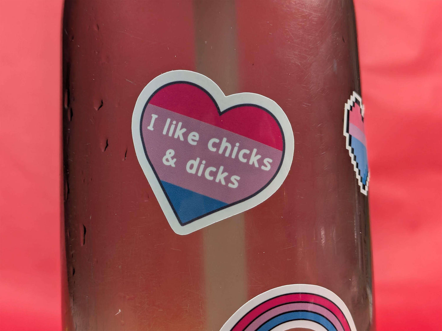 Sticker with text 'I like chicks & dicks' on a red background