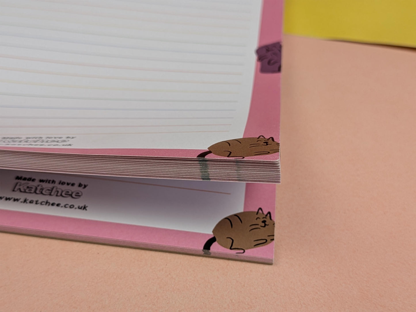 Notebook with cat illustrations on a pink cover