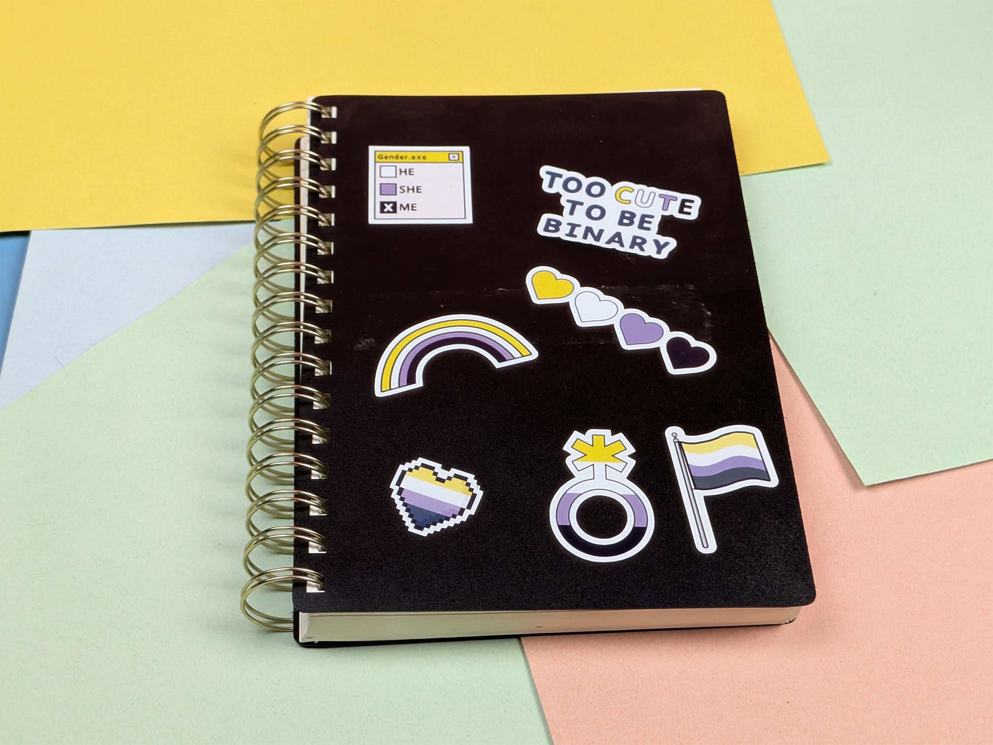 Black notebook with stickers on a colorful background