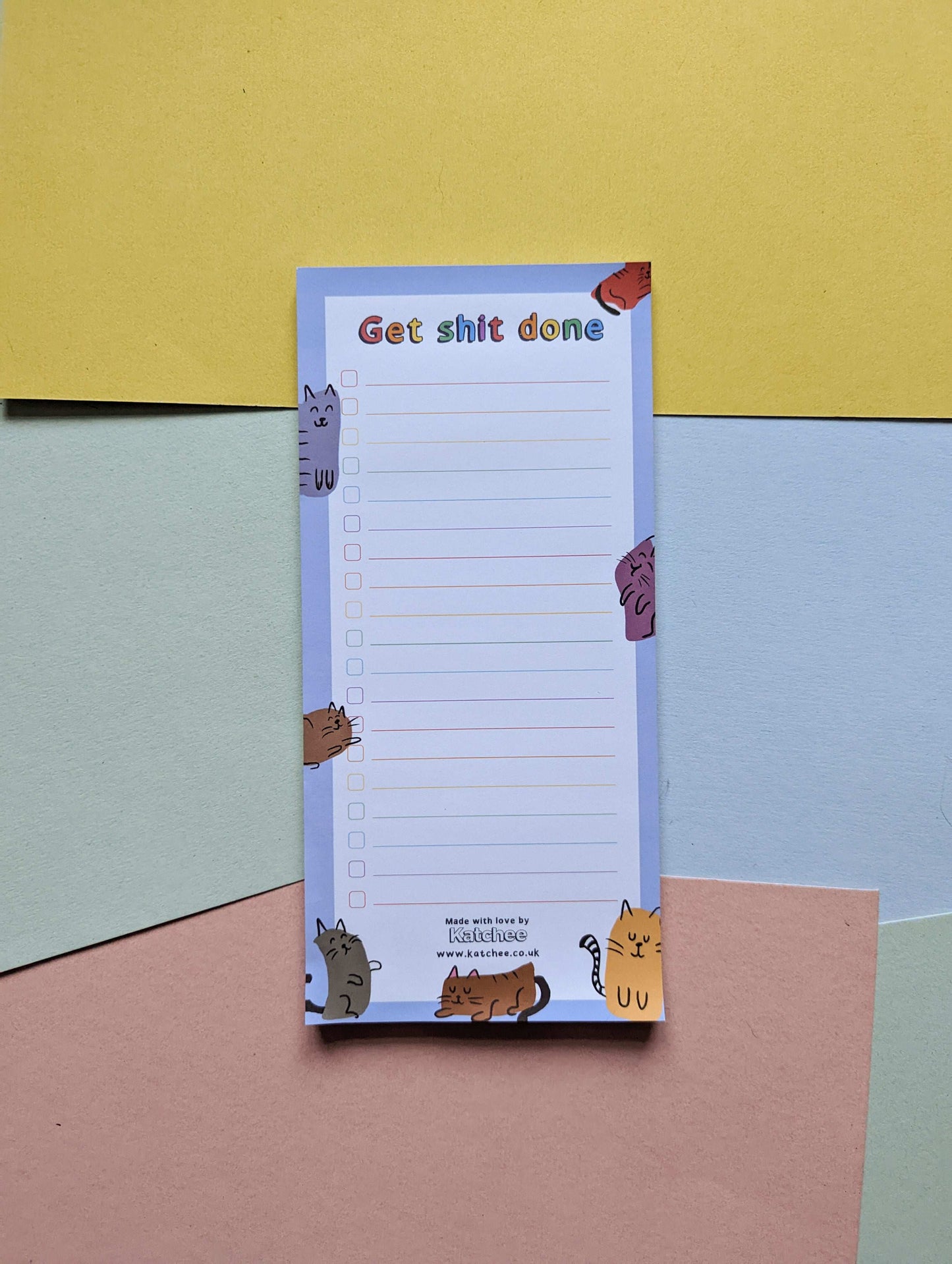 Notepad with cat illustrations on a colorful background