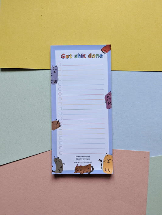 Notepad with cat illustrations on a colorful background