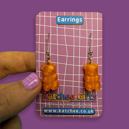 Gummy bear-shaped earrings on a Katchee Gifts card with a purple background