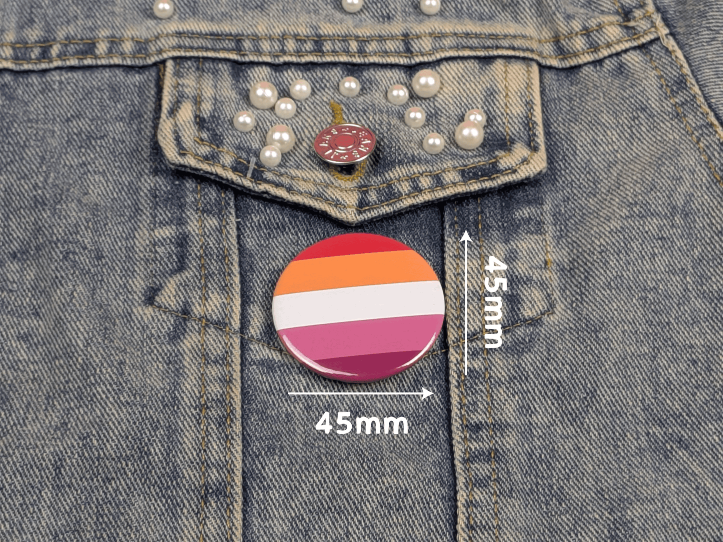 lesbian flag button badge on a denim jacket with measurements indicated