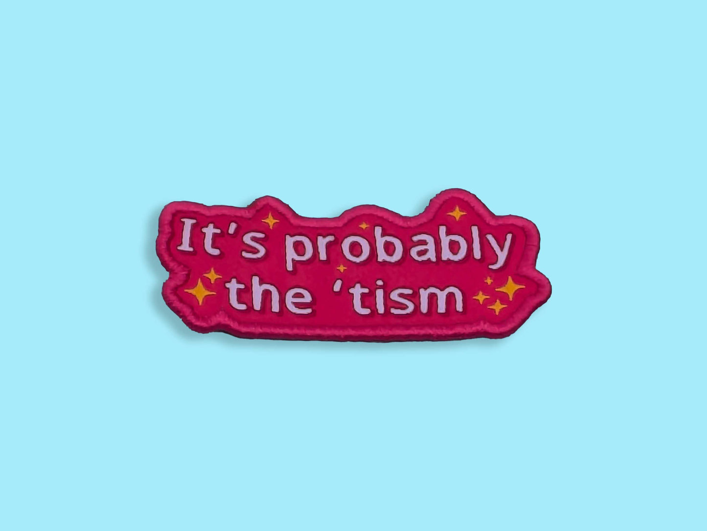 Pink patch with text 'It's probably the 'tism' on a light blue background