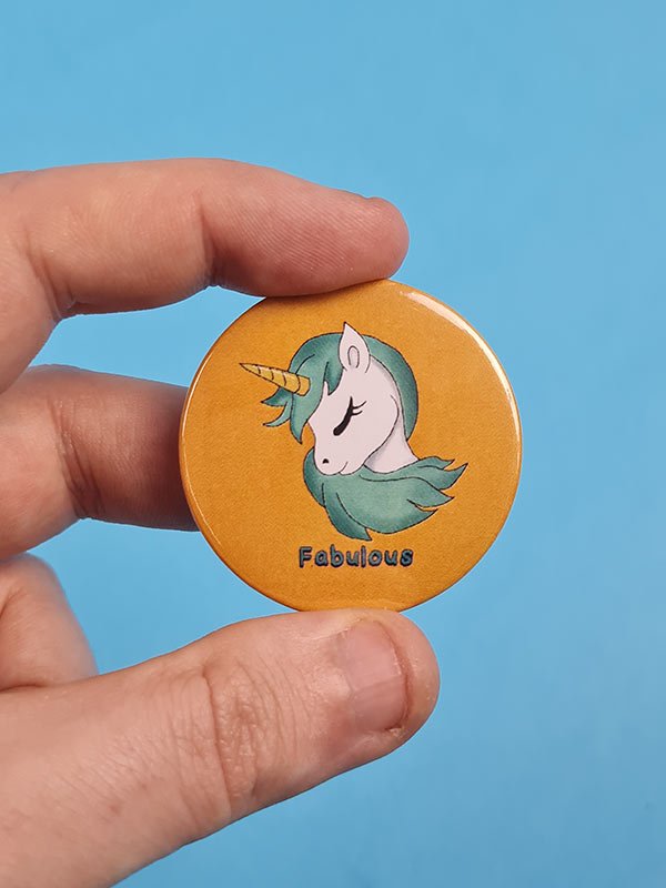 Yellow unicorn badge handheld