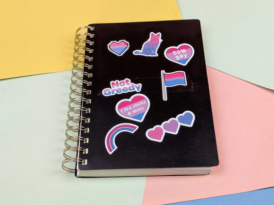 Black notebook with colorful stickers on a multicolored background
