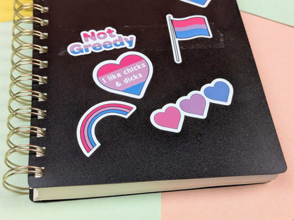 Black notebook with colorful stickers on a multicolored background
