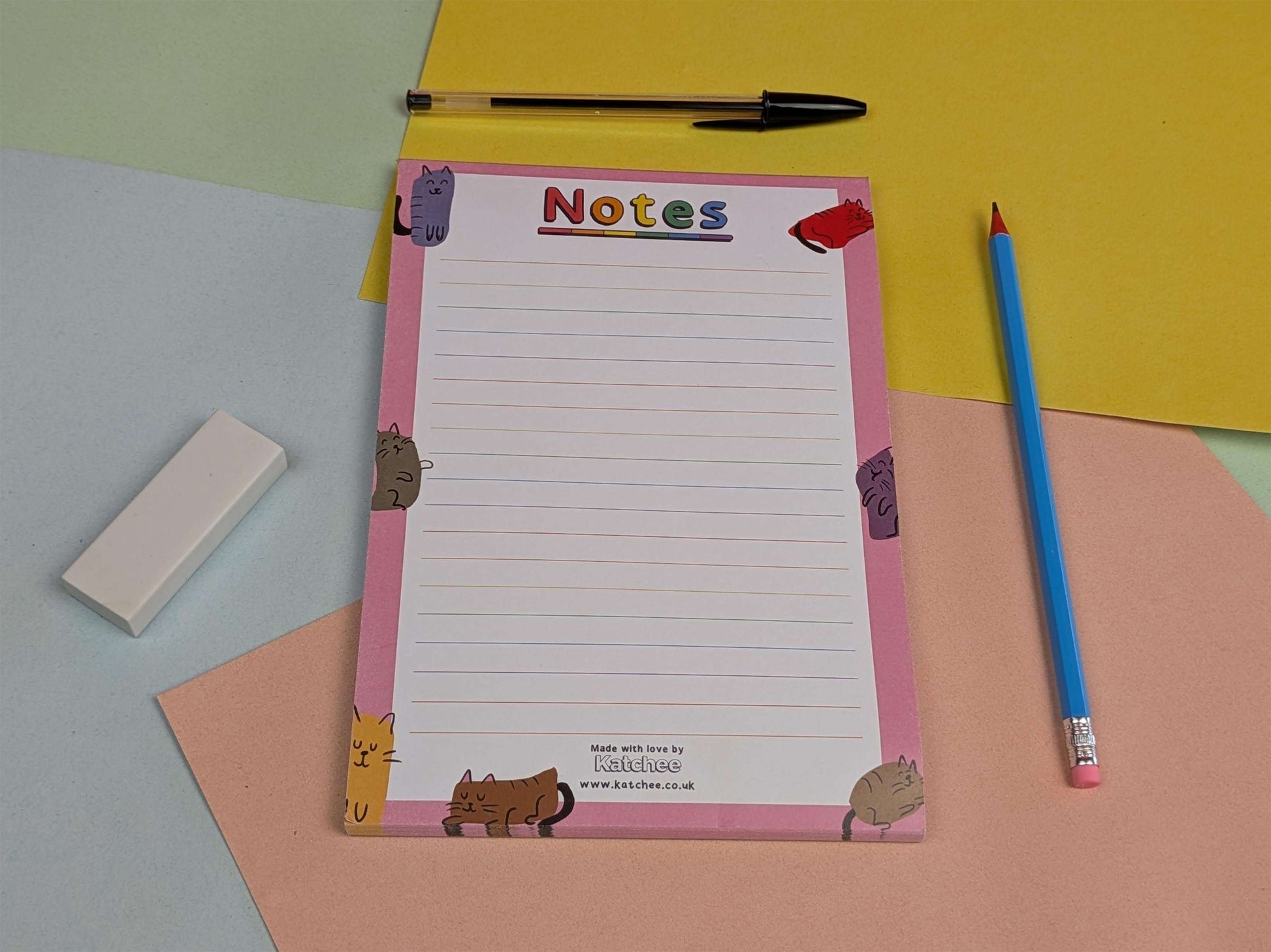 Notepad with animal illustrations on a colorful background with a pen and eraser.
