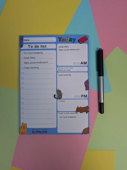 To-do list pad with a pen on a colorful geometric background