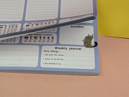 Image showing the pages flipped up, this is a desk planner with daily trackers.
