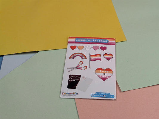 Sticker sheet with rainbow flag, scissors, and heart designs on a colorful background