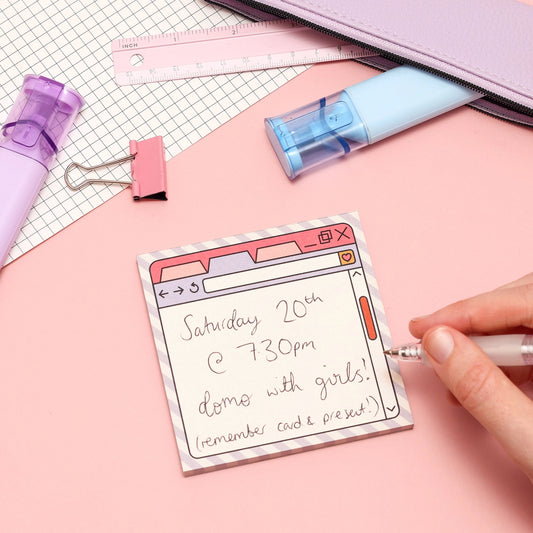 Note with event details on a pink surface with stationery items