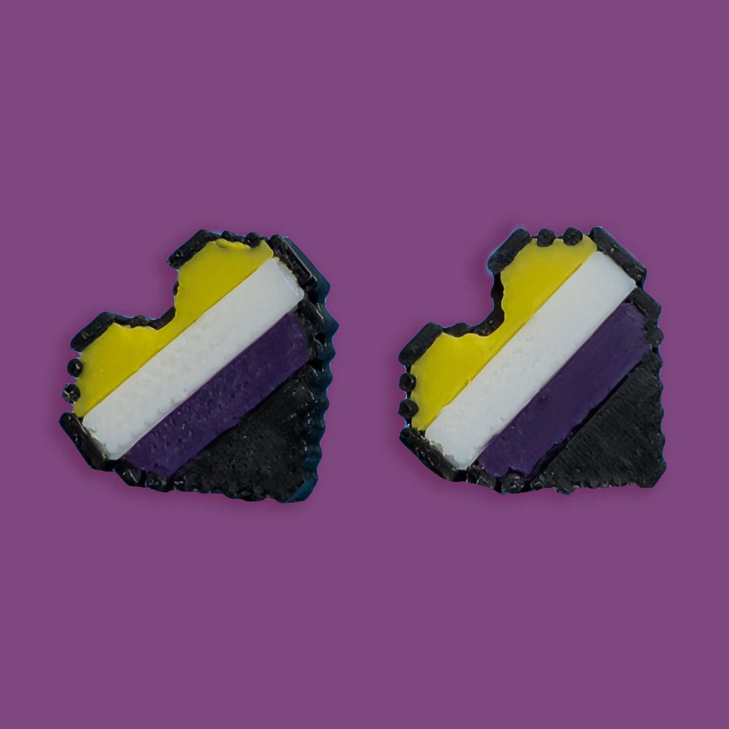 Heart-shaped earrings with a black, yellow, and purple striped design on a purple background