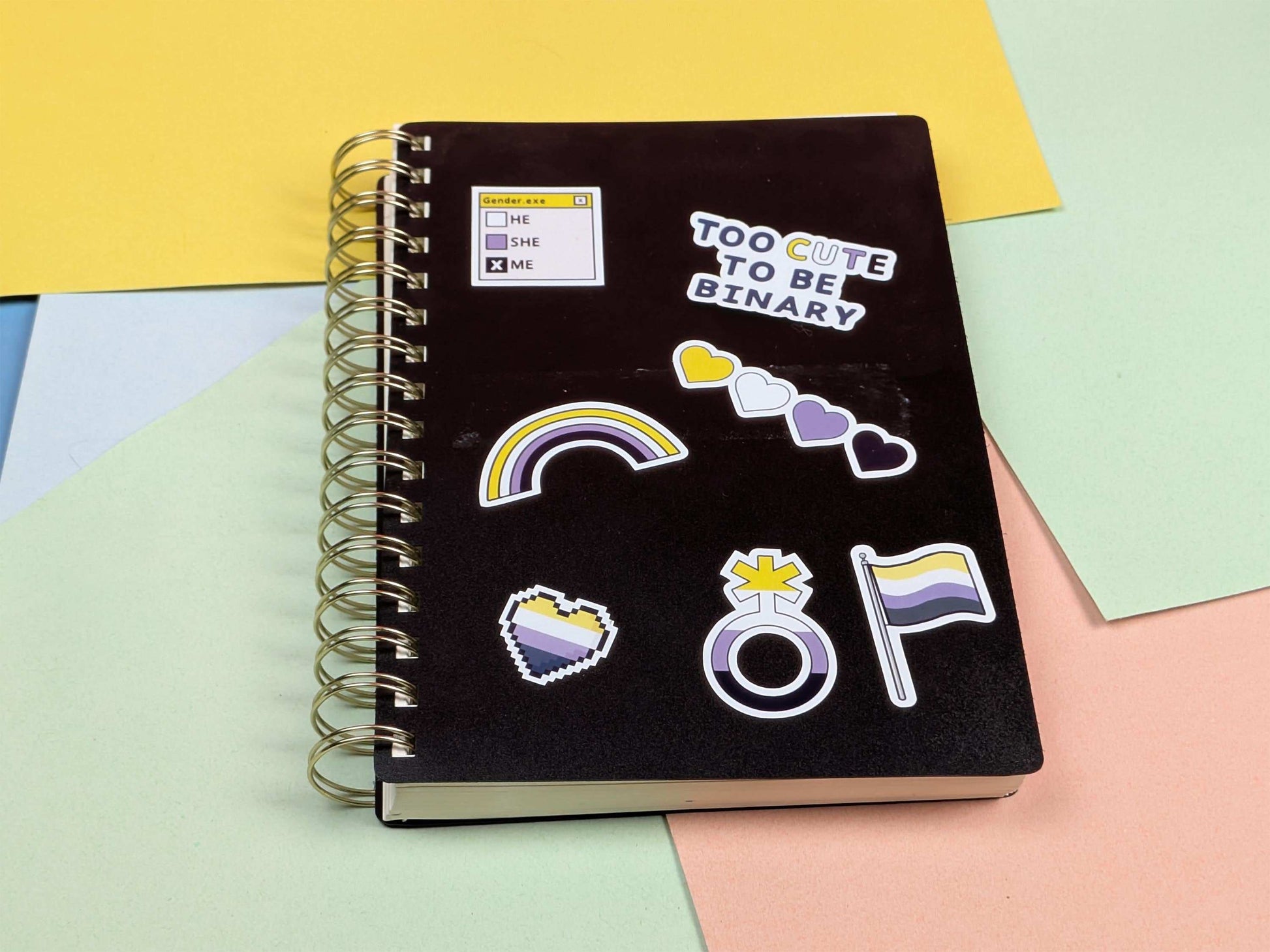 Black notebook with stickers on a colorful background