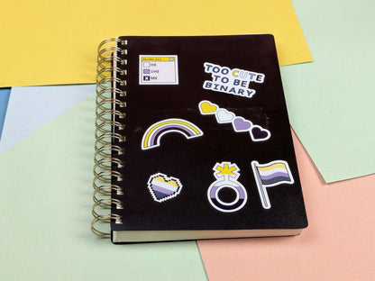 Black notebook with stickers on a colorful background