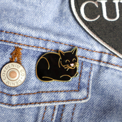 Black cat pin on a denim jacket 