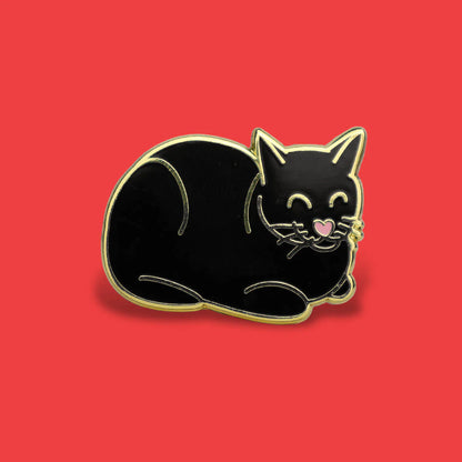 Black cat-shaped pin on a red background
