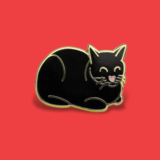 Black cat-shaped pin on a red background