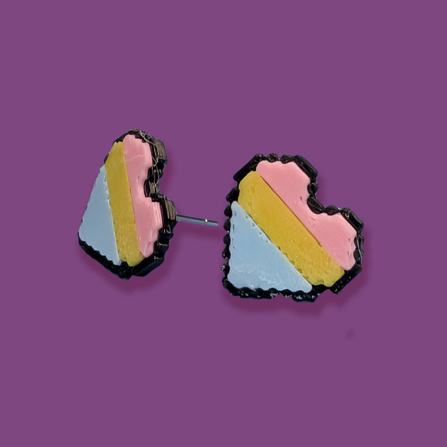 Colorful geometric earrings on a purple background
