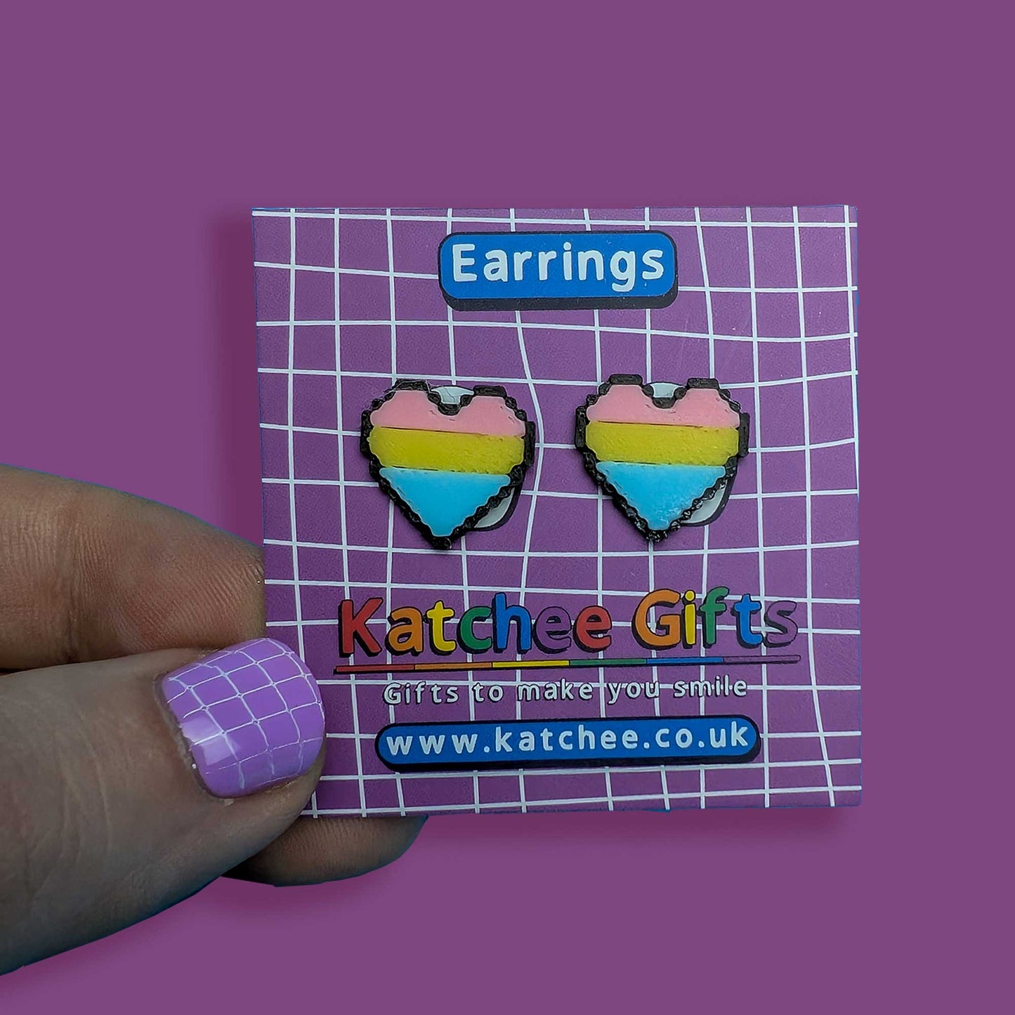 Heart-shaped earrings on a Katchee Gifts card with a purple background