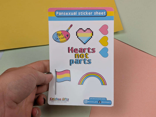Pansexual sticker sheets with hearts not parts design held by a hand on a colorful background