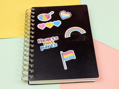 Black notebook with colorful stickers on a multicolored background