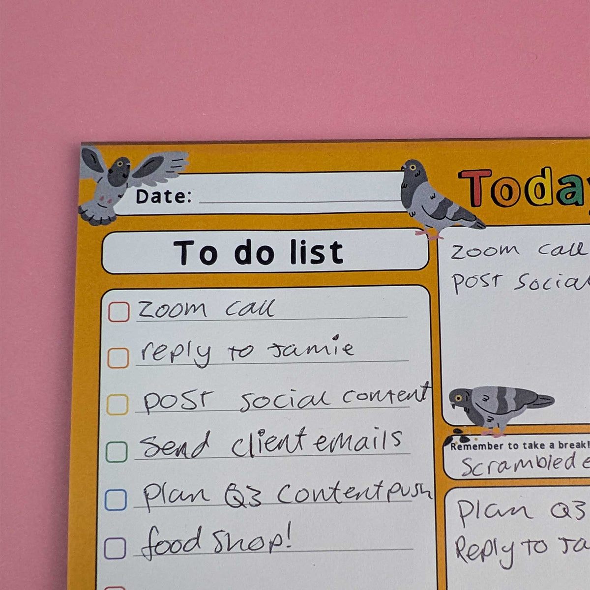 A close-up of a yellow and white to-do list planner or poster with pigeon illustrations, showing handwritten tasks like 'zoom call' and 'reply to jamie' against a pink background.