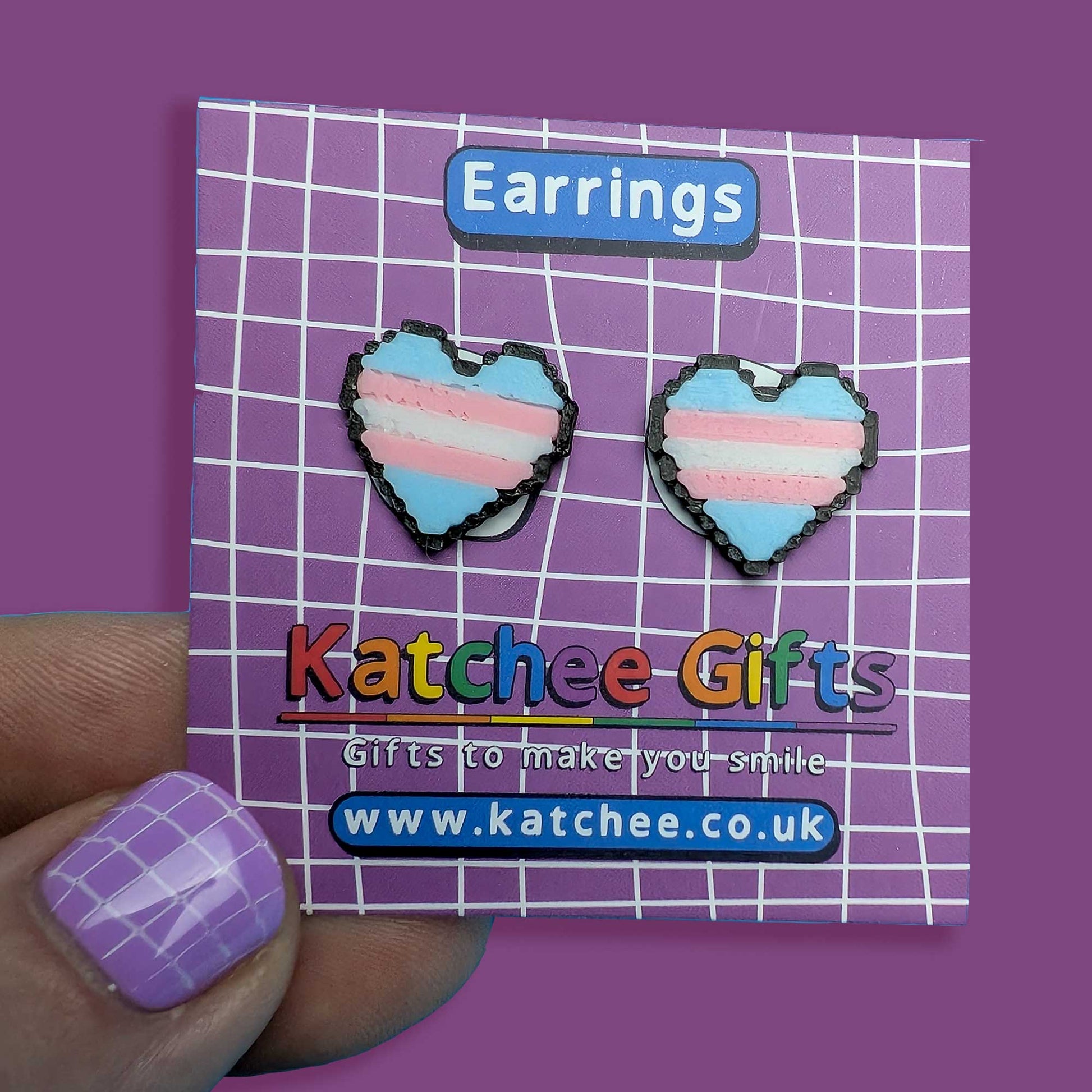 Heart-shaped earrings on a Katchee Gifts card with a purple background