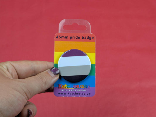 Rainbow-colored packaging with a 45mm pride badge on a red background