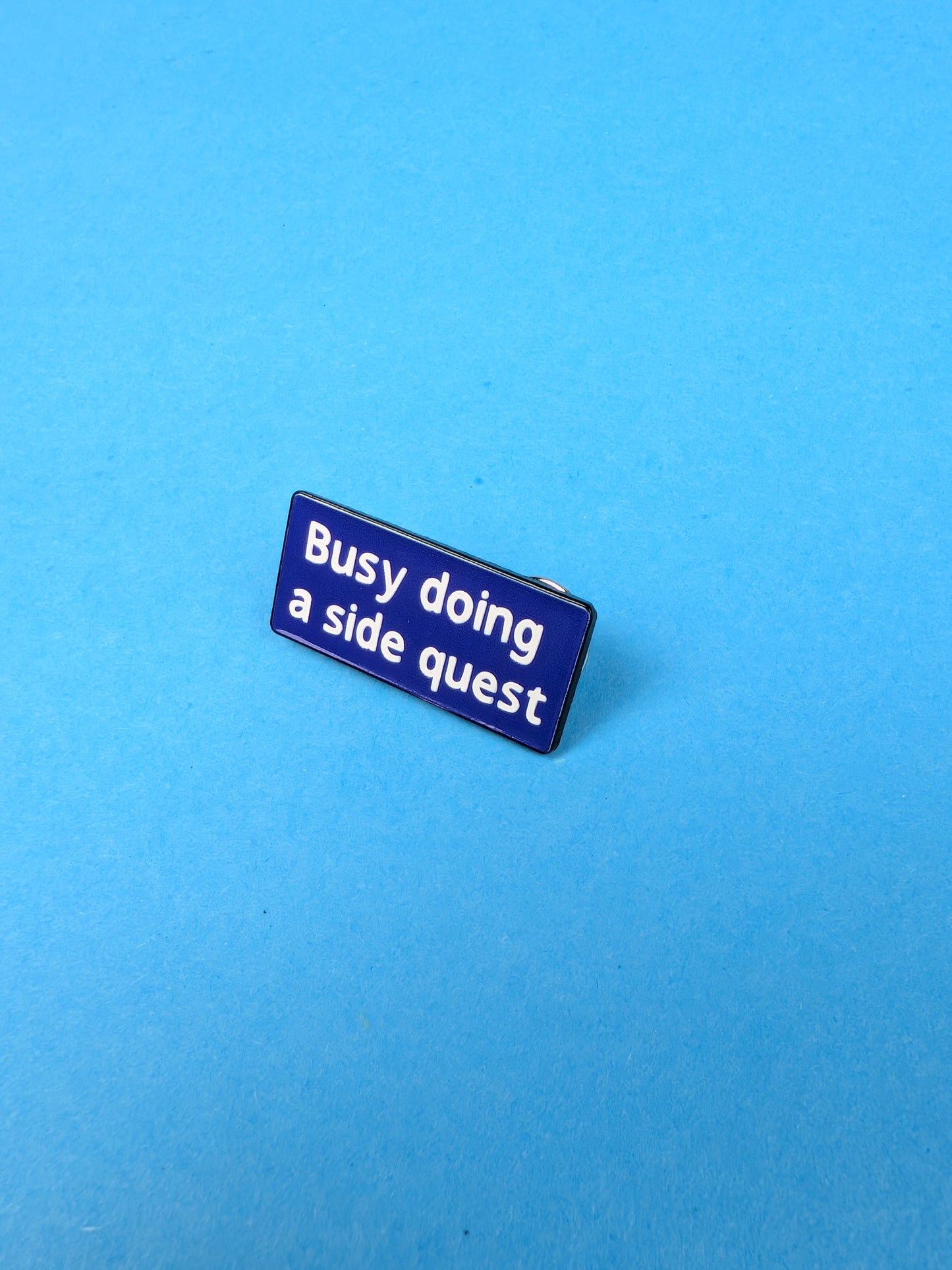 Blue badge with text 'Busy doing a side quest' on a blue background
