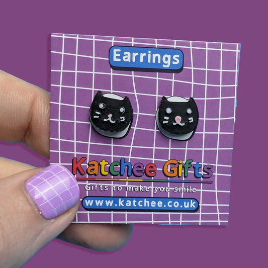 Cat-shaped earrings on a Katchee Gifts card with a purple background