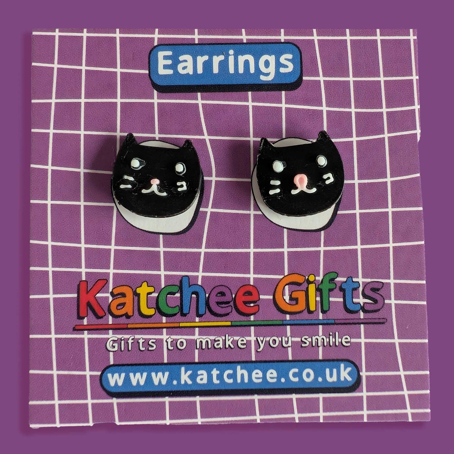 Black cat-shaped earrings on a purple grid background with 'Katchee Gifts' branding.