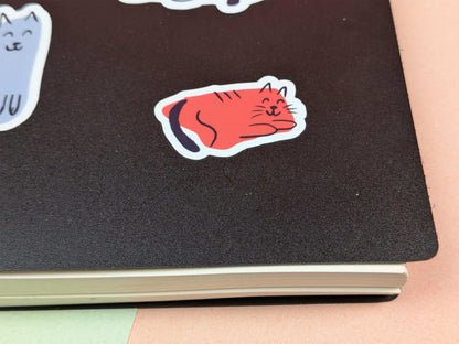 Notebook with a red cat sticker 