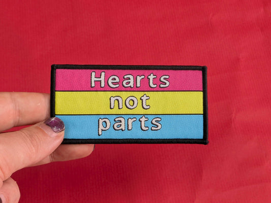 Patch with 'Hearts not parts' text on a red background
