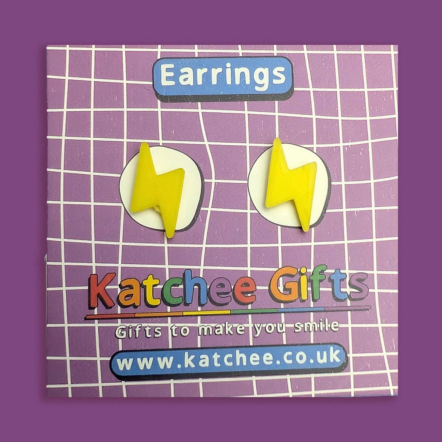 Yellow lightning bolt earrings on a purple grid background with 'Katchee Gifts' branding.