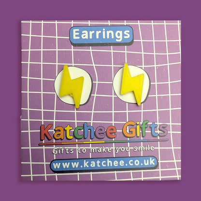 Yellow lightning bolt earrings on a purple grid background with 'Katchee Gifts' branding.