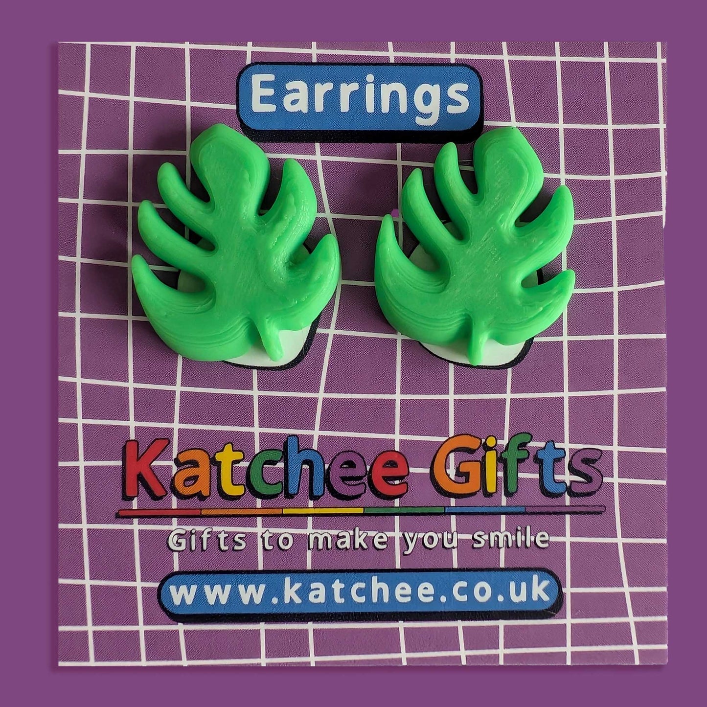 Green leaf-shaped earrings on a purple grid background with 'Katchee Gifts' branding.