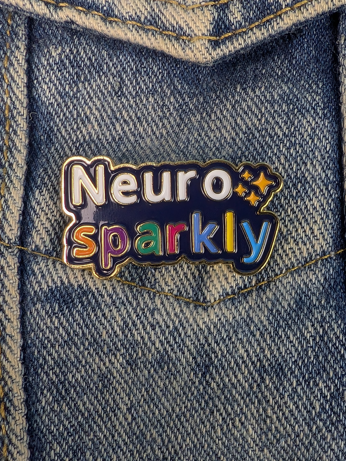 Neuro Sparkly pin on a denim jacket