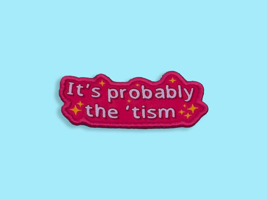 Pink patch with text 'It's probably the 'tism' on a light blue background