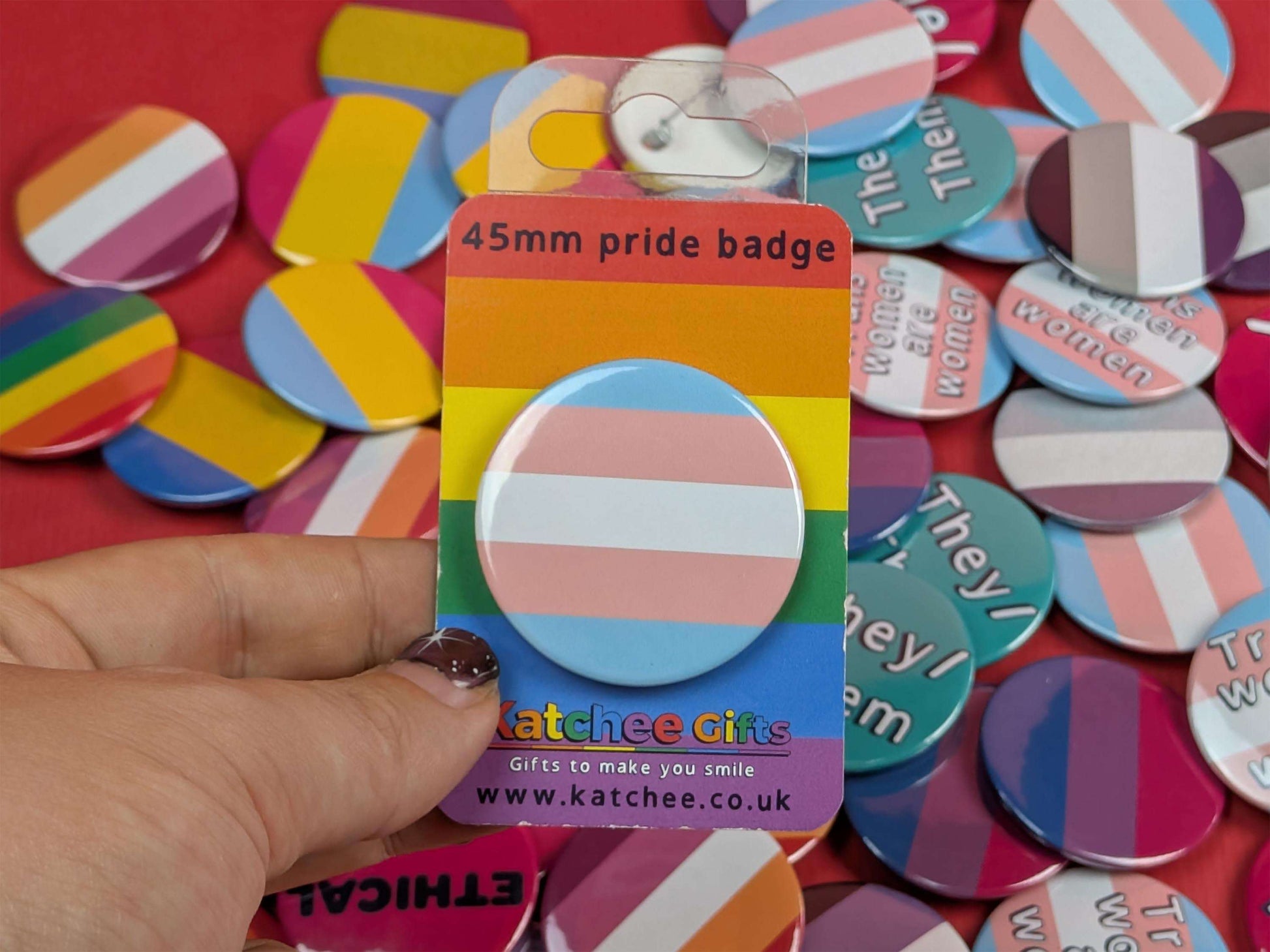 Pride badge in packaging with a rainbow design on a colorful background
