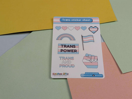 Trans sticker sheet with pride-themed designs on a colorful background